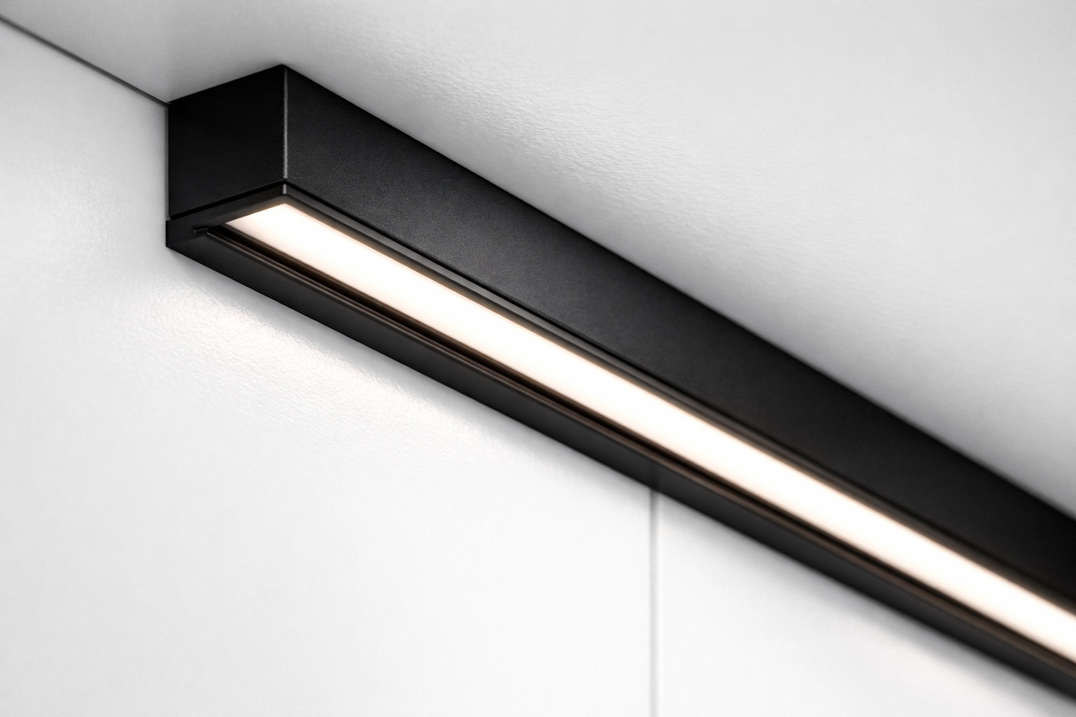 Sleek matte black aluminum LED channel professionally mounted for integrated cabinet lighting.