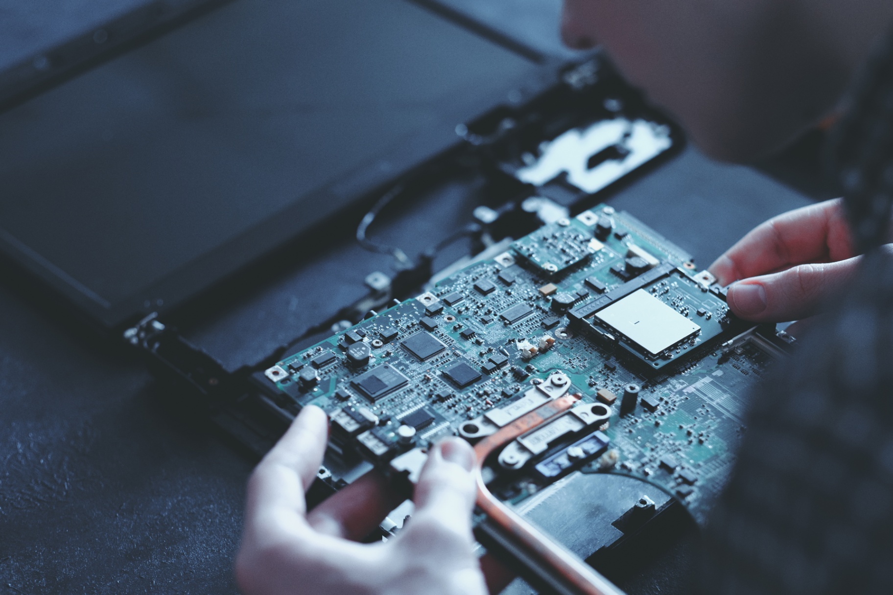 Technician Repairs Laptop Motherboard