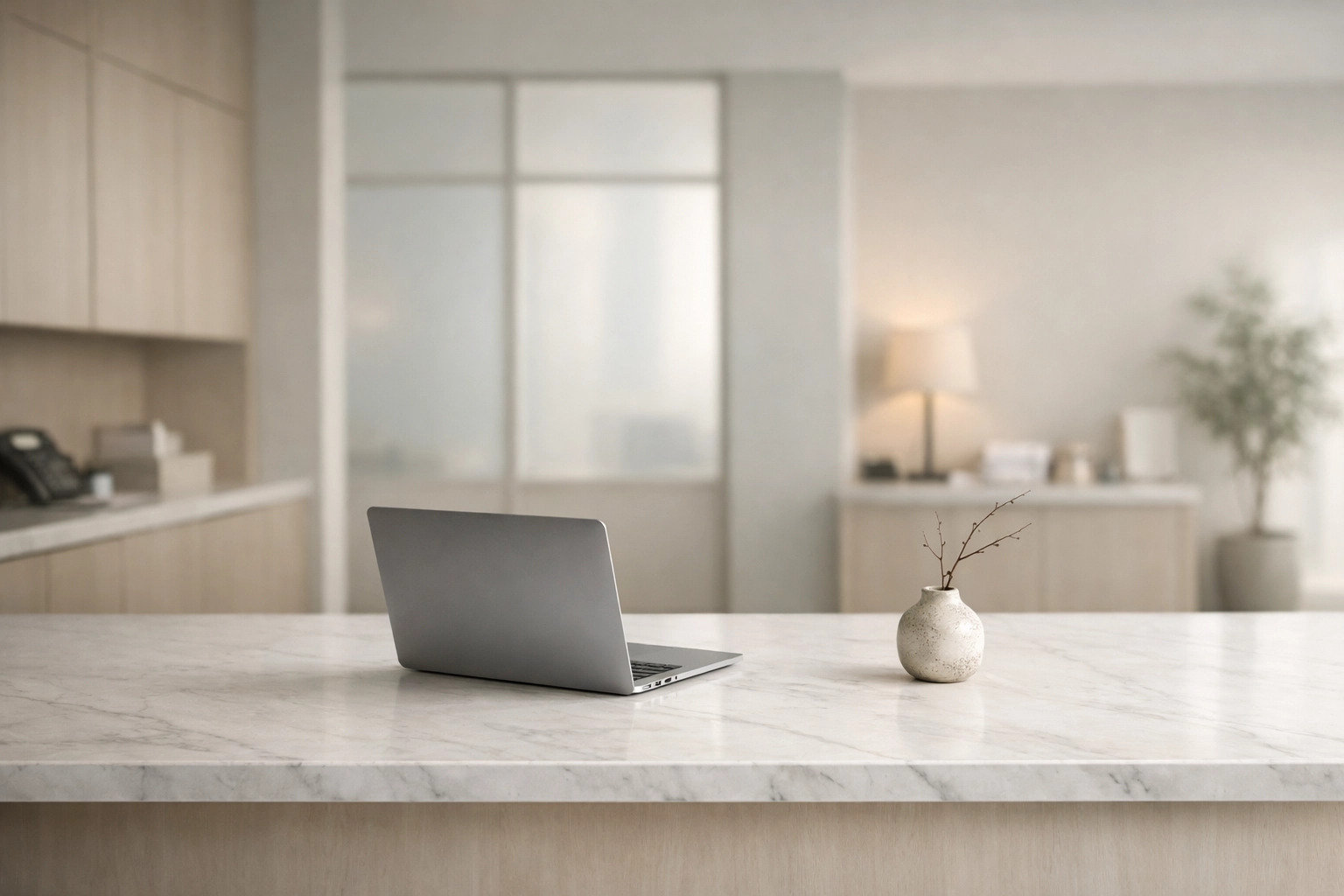 Modern hotel back office with a sleek laptop representing secure cloud-native PMS technology.