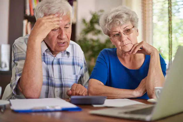 Confused couple reviewing insurance documents