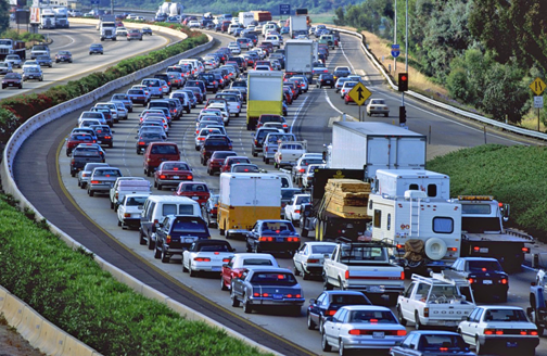 Heavy freeway traffic highlighting the need for real-time GPS tracking and dash cameras to improve safety and reduce accident risks during congested travel.