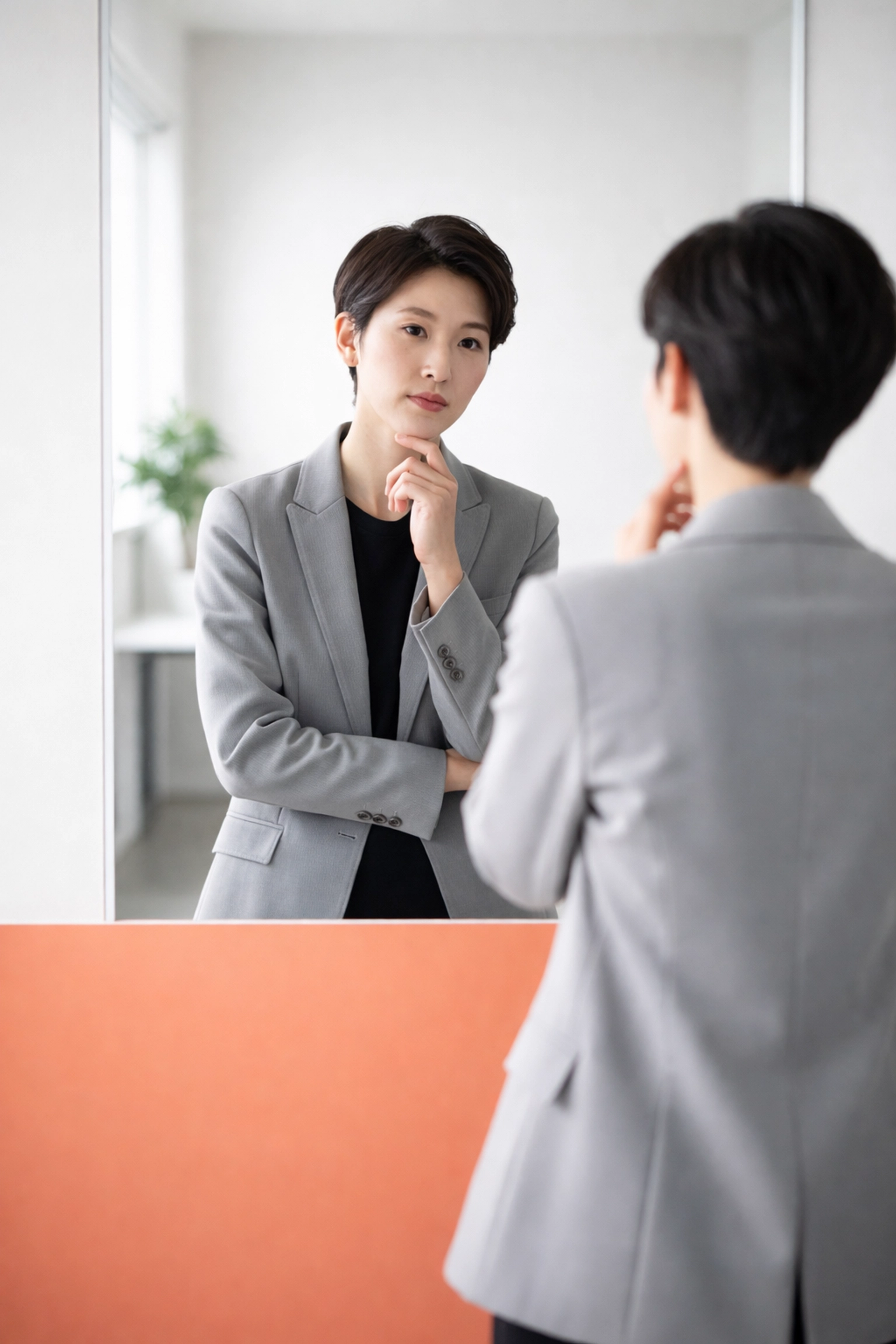 Leader reflecting in a modern office mirror, representing self-assessment in empathetic leadership