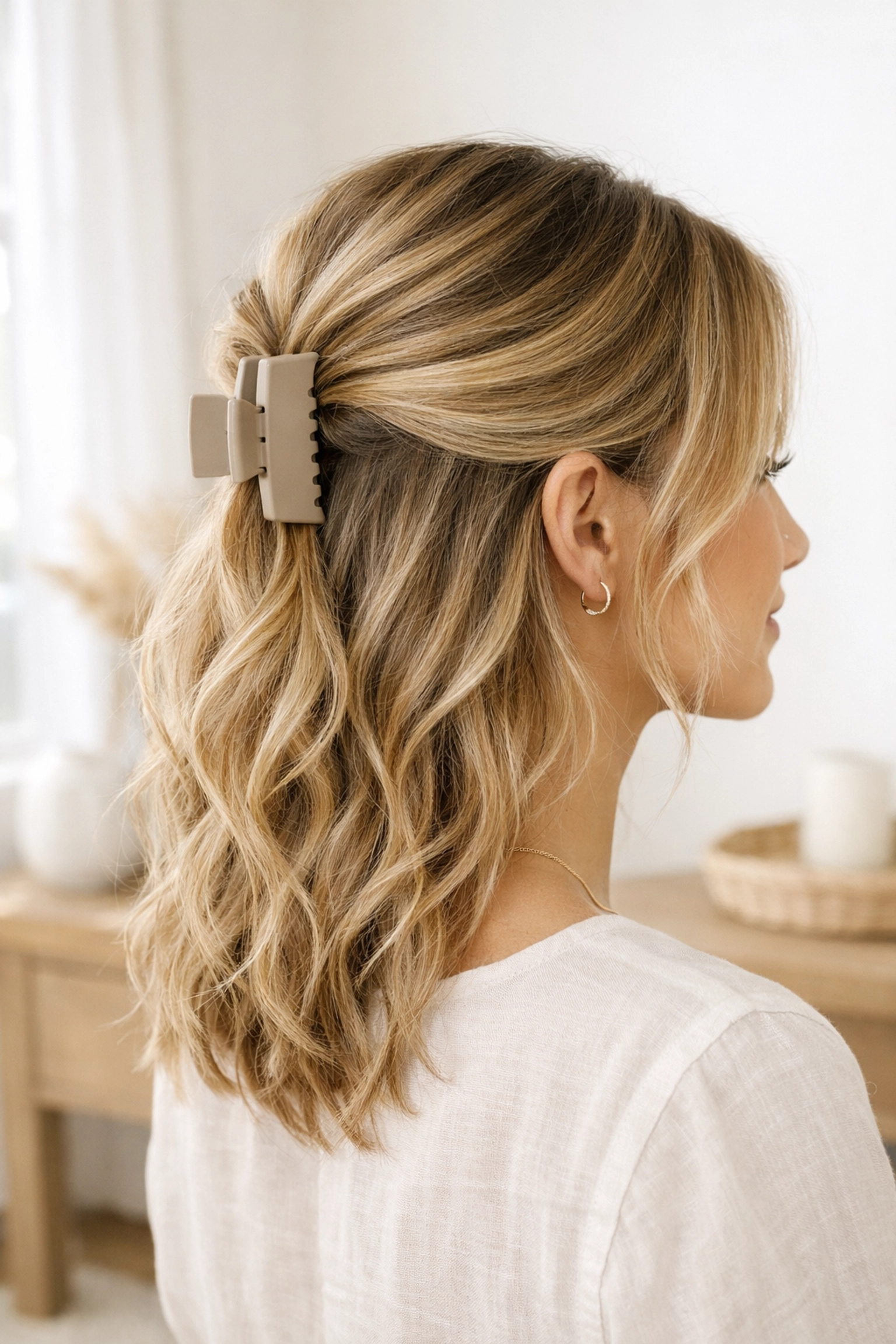 Trendy half-up claw clip hairstyle with soft beachy waves for everyday wear.