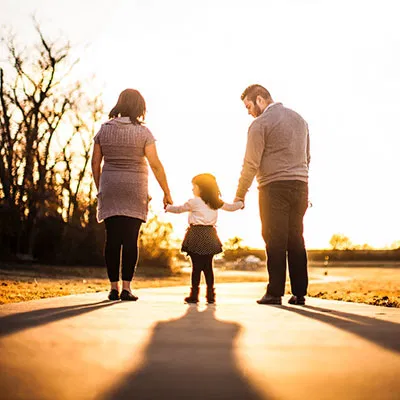 A family walking together at sunset, symbolizing the unity and successful relocation services provided by Migrate2Australia.