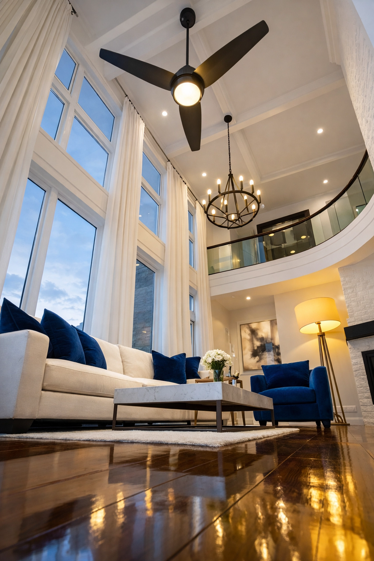 High-ceiling living room illustrating a top-to-bottom cleaning strategy from ceiling fan to floor.