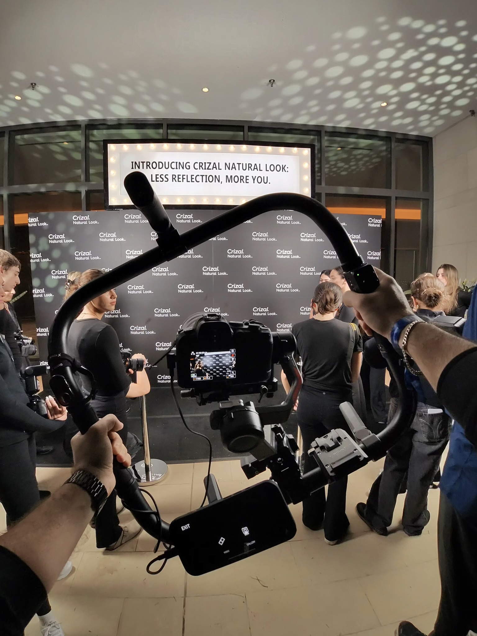 Behind-the-scenes paparazzi chaos at SWITCH Summit black carpet activation — controlled chaos and hustle.