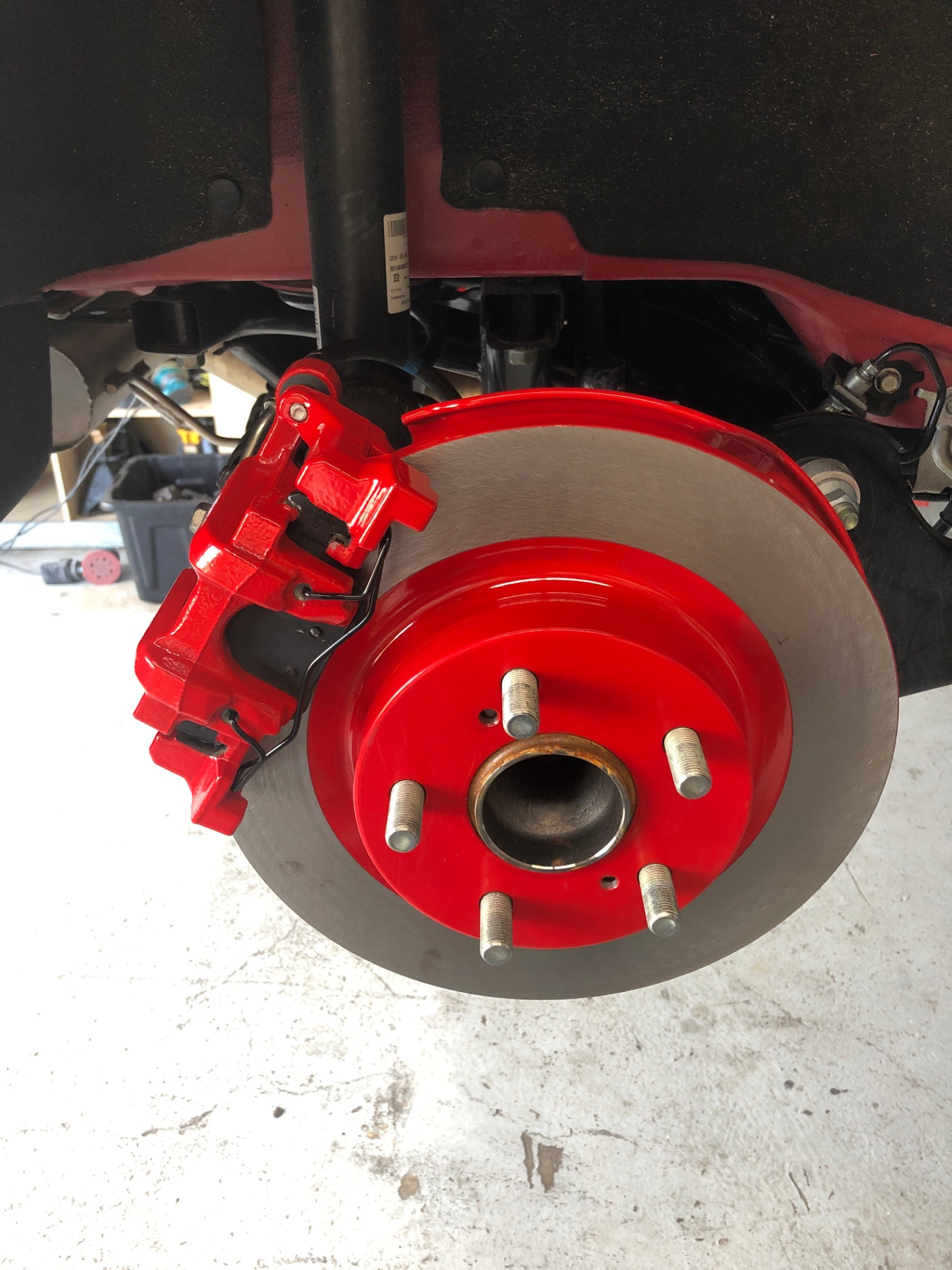 After: powder coated caliper and bracket installed behind the wheel