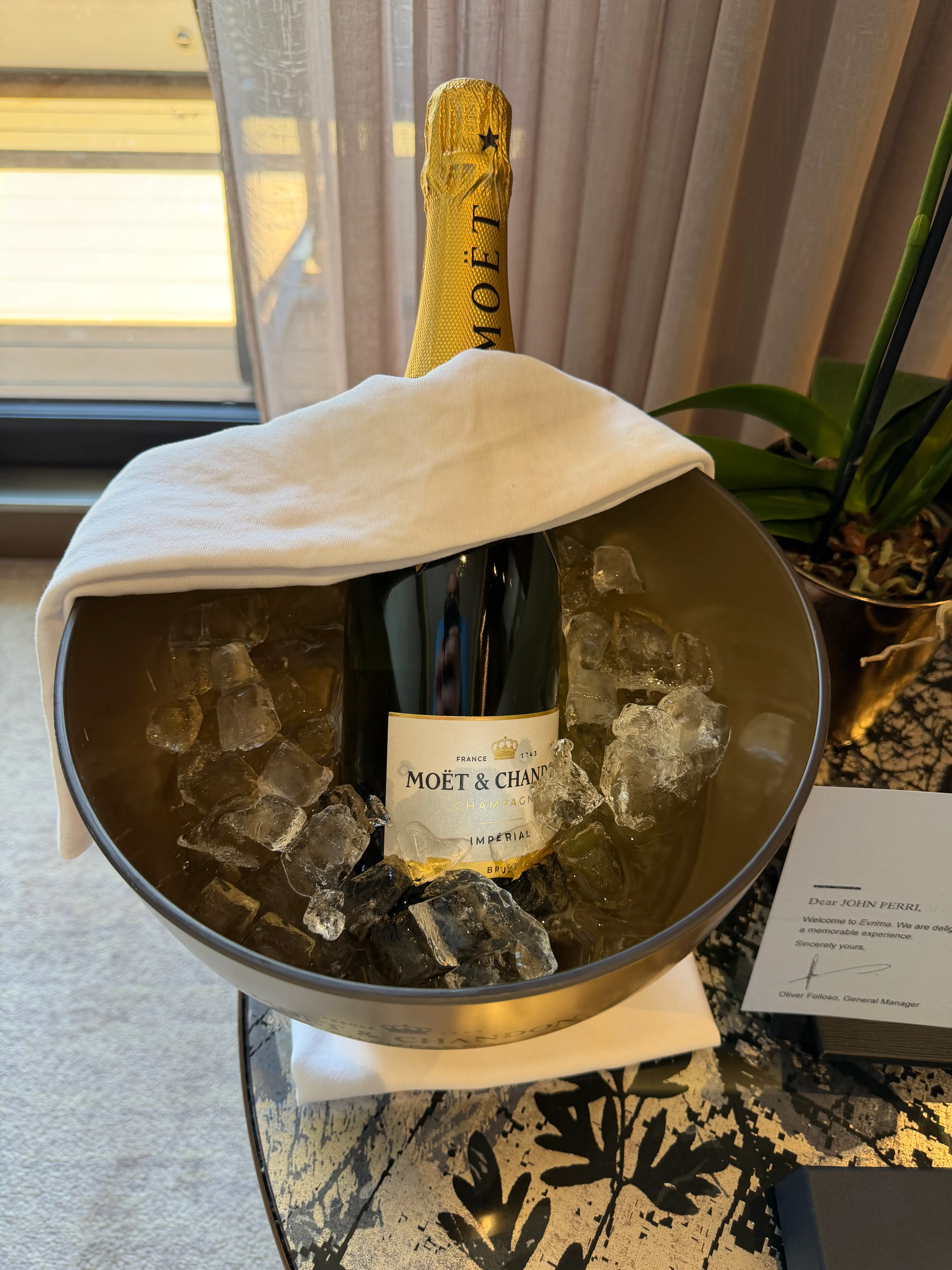 a bottle of champagne in a bowl of ice
