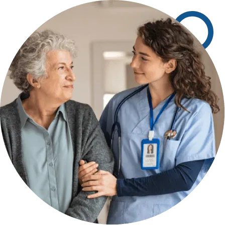 A dedicated BestCare24 caregiver in uniform, with a visible name badge, gently supports an elderly woman in a home setting, reflecting trust, empathy, and personalised care.