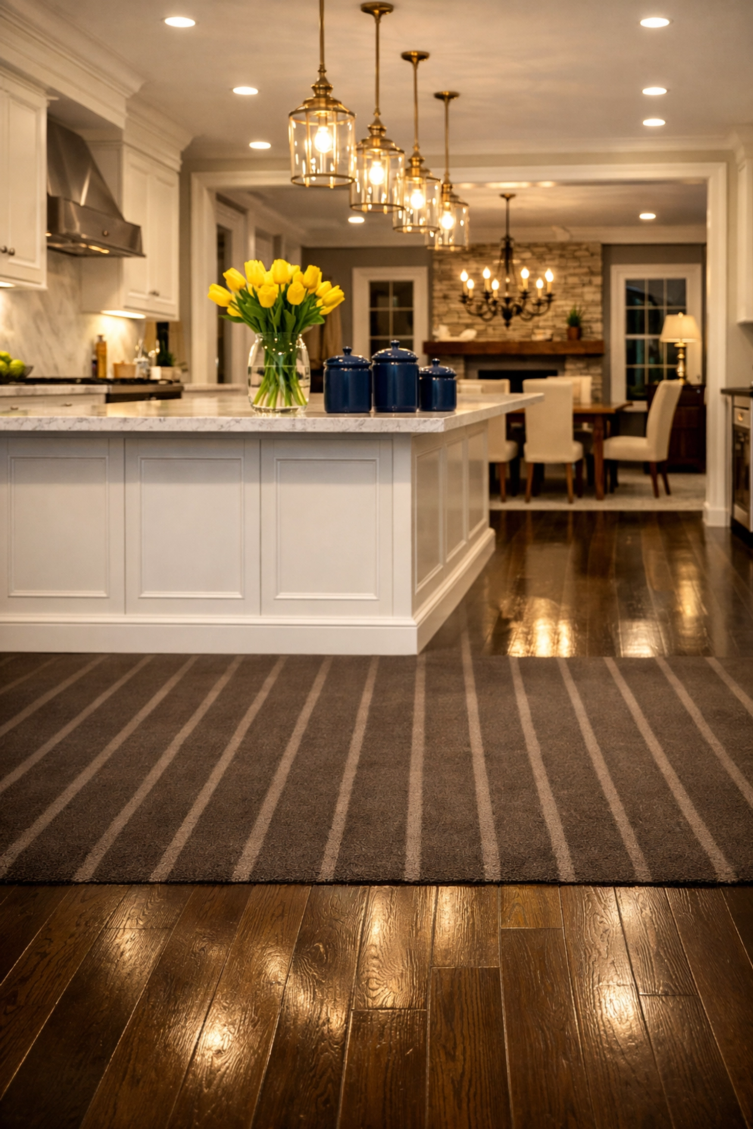 Open-concept kitchen with vacuum lines on wood floors by professional house cleaning in Sherborn, MA.
