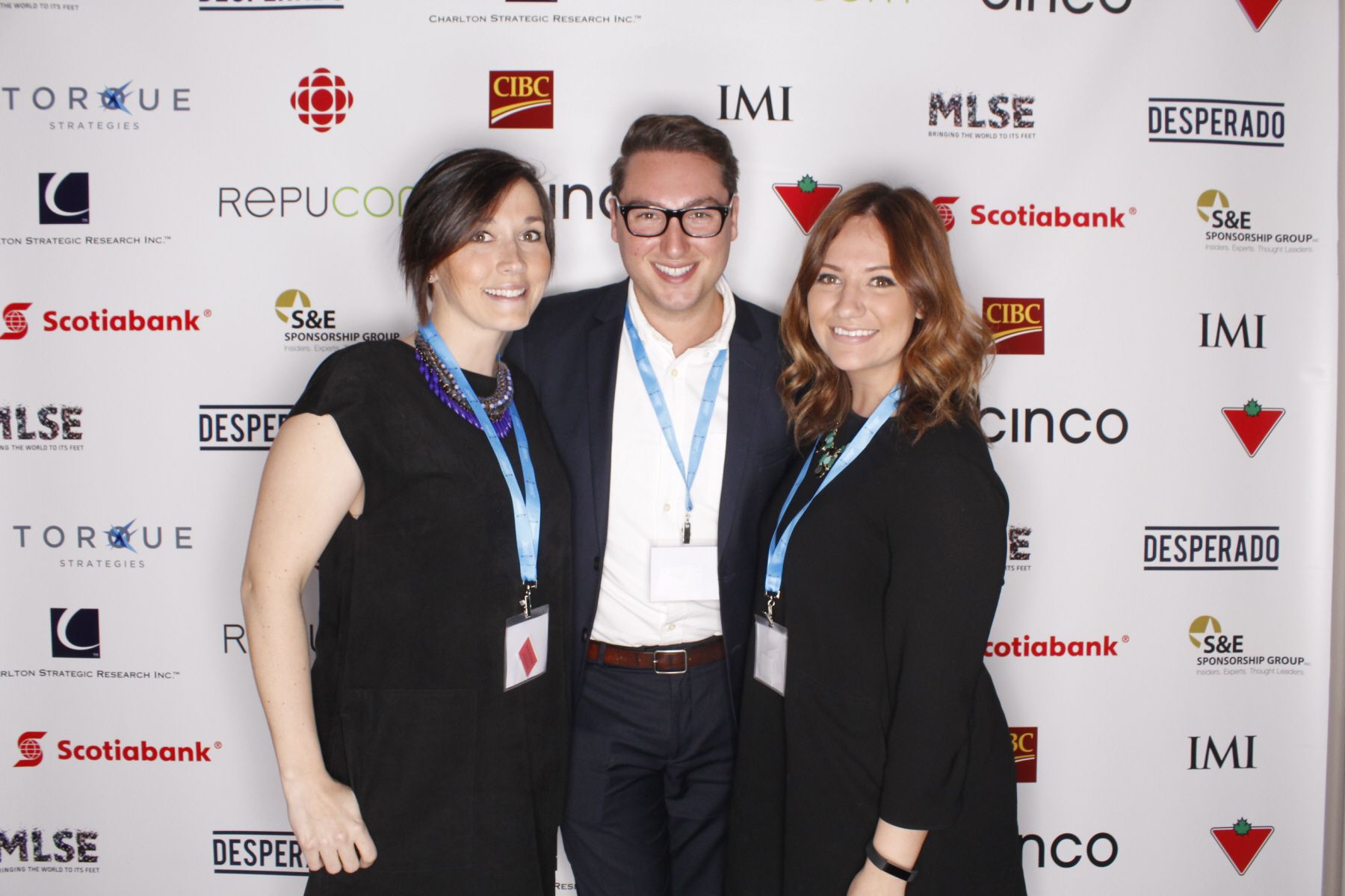 Corporate networking event with a professional branded step-and-repeat backdrop activation