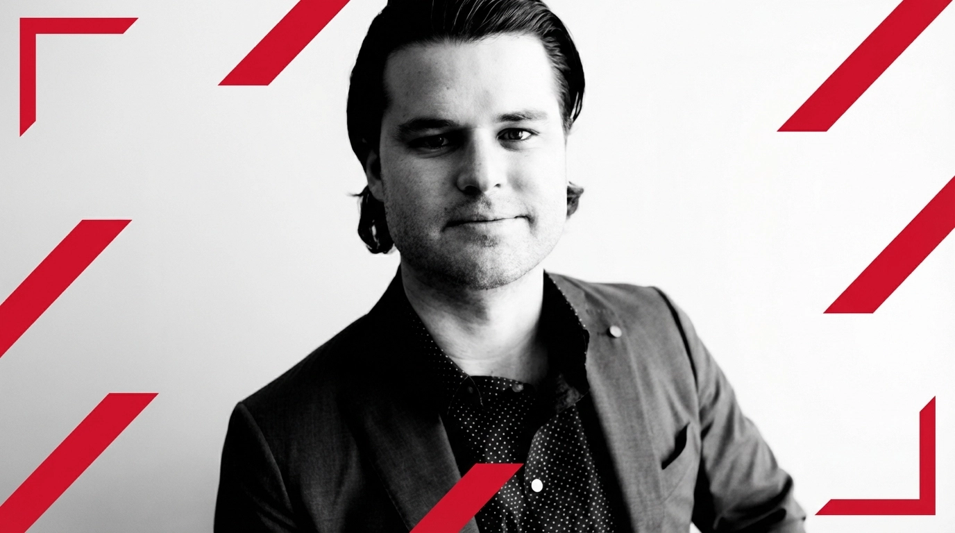 A professionally dressed man sits confidently against a neutral background, representing a Keller Williams Realty Integrity Lakes agent. His attire reflects a modern, business-casual look suitable for client meetings or marketing materials, emphasizing professionalism and approachability within the real estate industry.