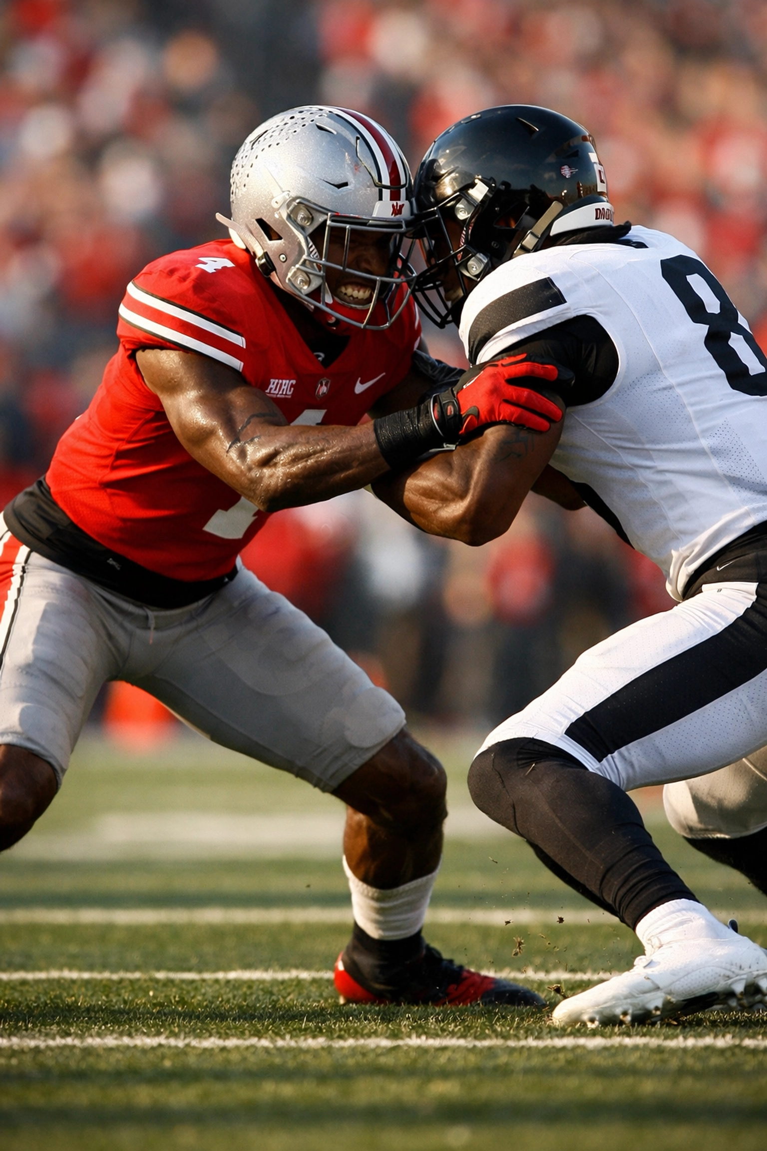 Ohio State defensive back making physical jam on receiver at line of scrimmage
