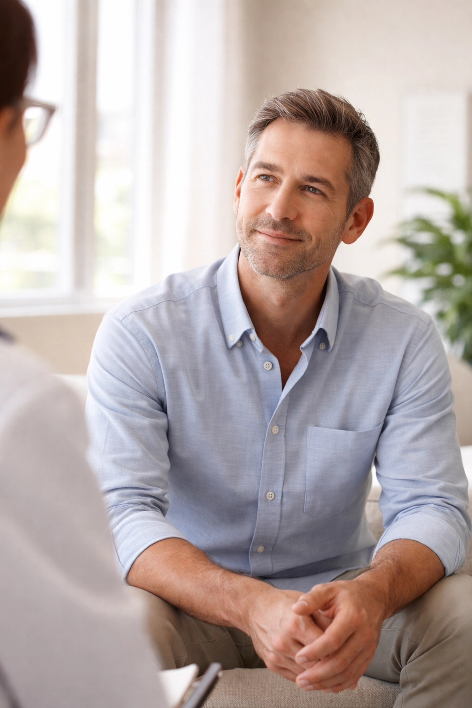 Middle-aged man discussing hormone evaluation with a healthcare provider in a modern Albuquerque clinic