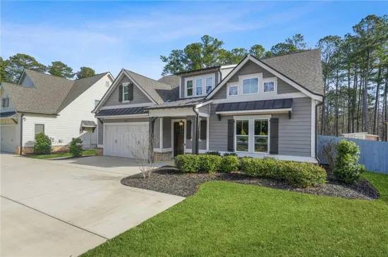 A charming traditional craftsman home in the heart of Acworth 30101, featuring a classic front porch and manicured spring landscaping, with a playful hand-drawn colorful frame accent.