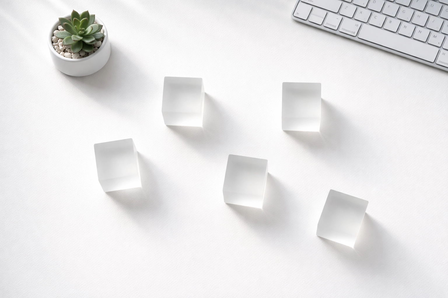 Minimalist workspace with five glass cubes symbolizing the essential WordPress SEO plugin stack