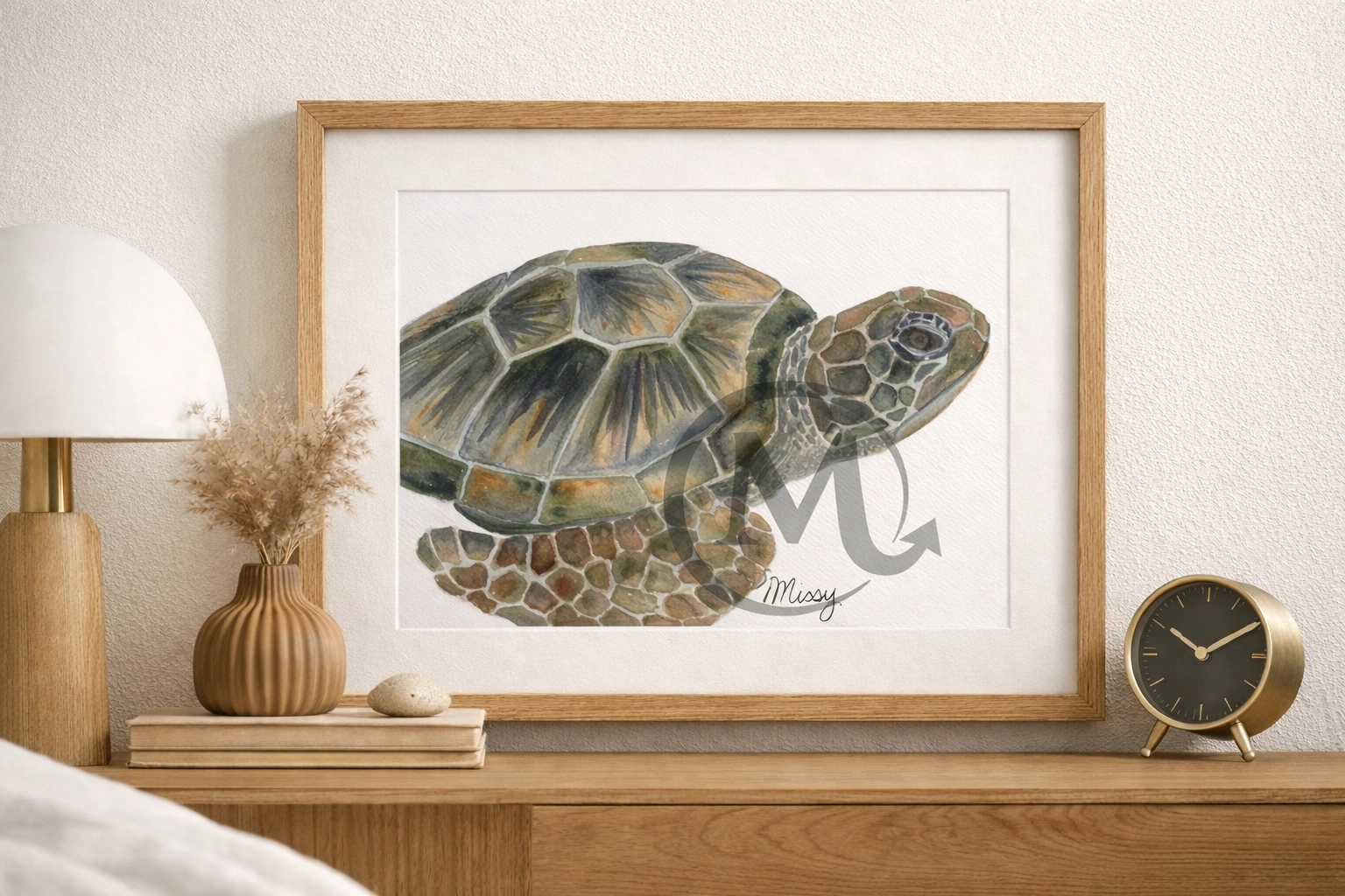 Missy’s original Shelly the Turtle watercolor displayed in a modern oak frame on a styled shelf with warm decor, with the original watermark and signature fully visible.