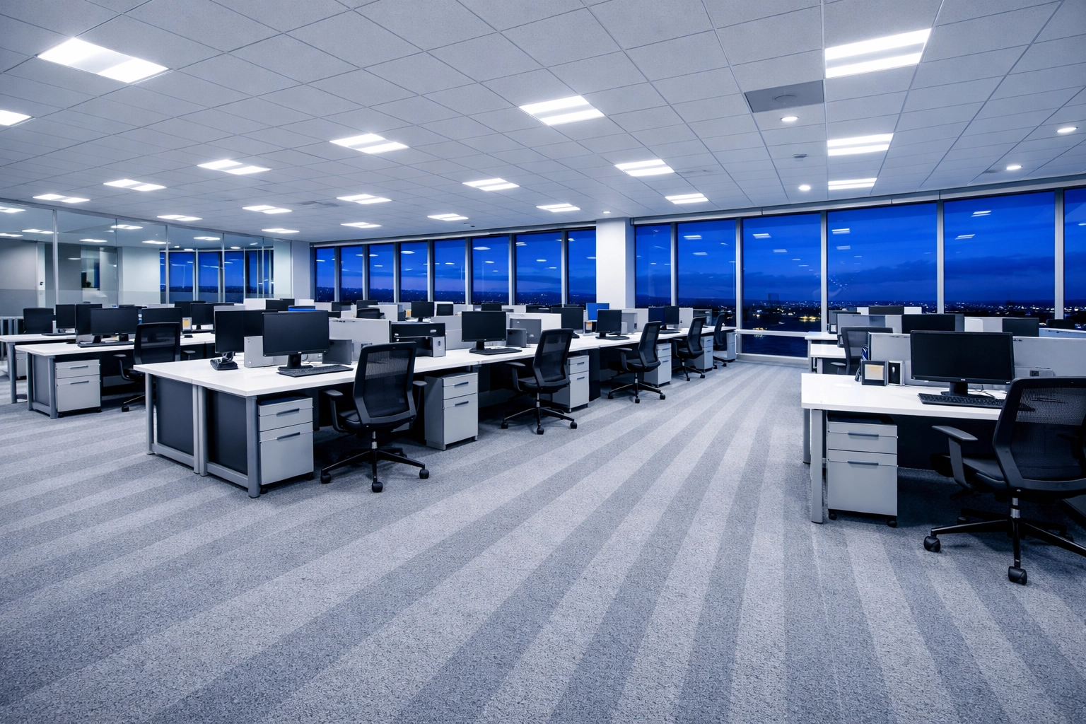 A clean, open-plan office with perfectly vacuumed carpets and tidy desks after a professional night clean.