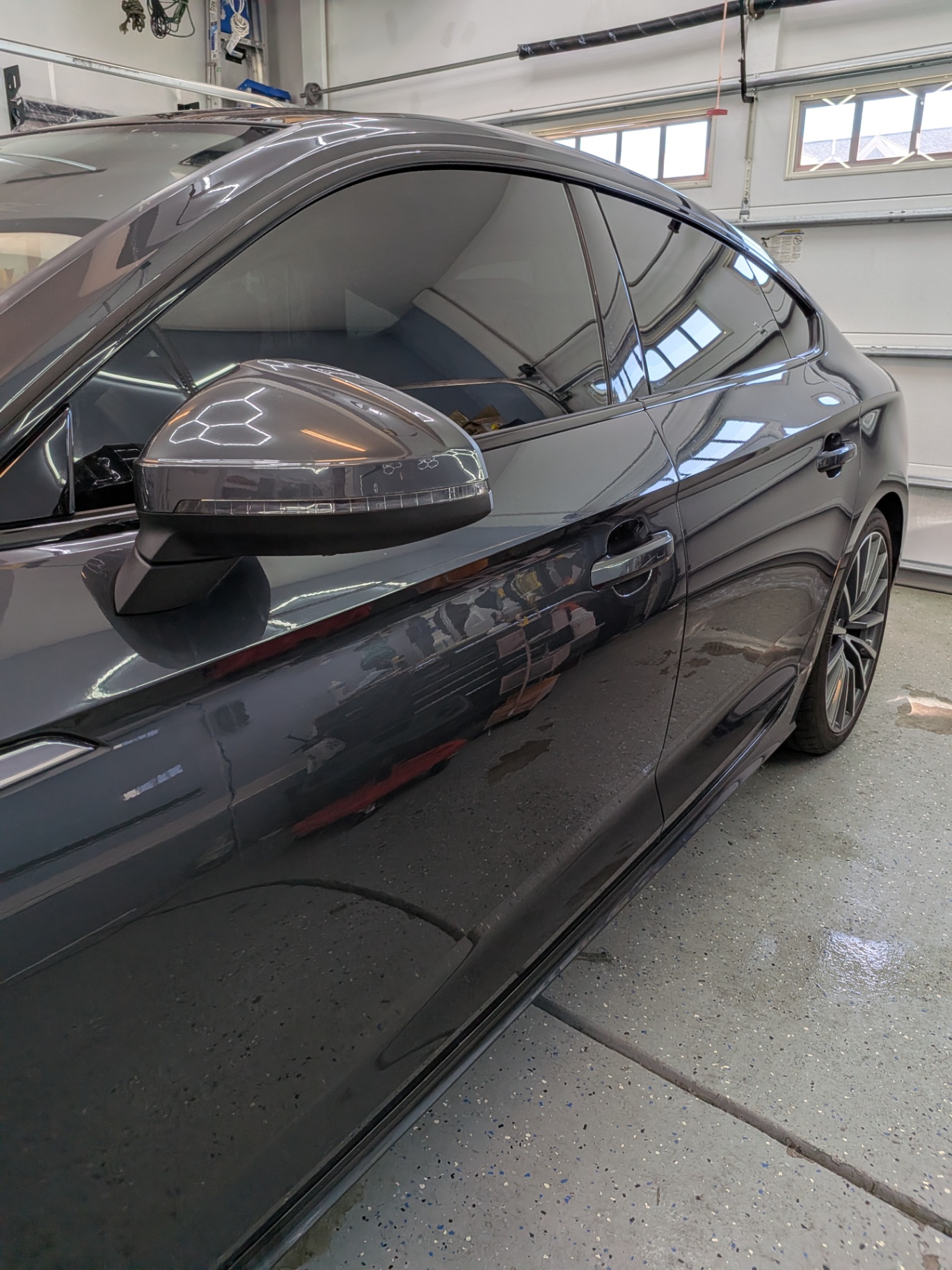 Dark tinted windows on a sleek black car