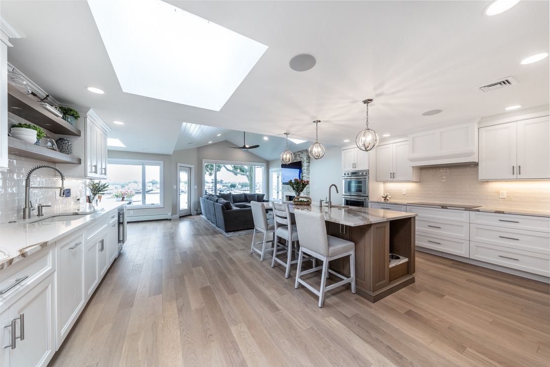 Open-concept biophilic kitchen design on Long Island with natural light, custom cabinets, and warm wood elements