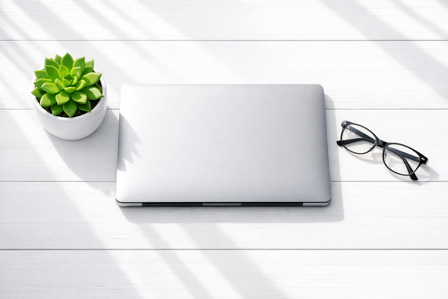 Professional laptop setup on a clean white desk representing a simplified online store and website build.