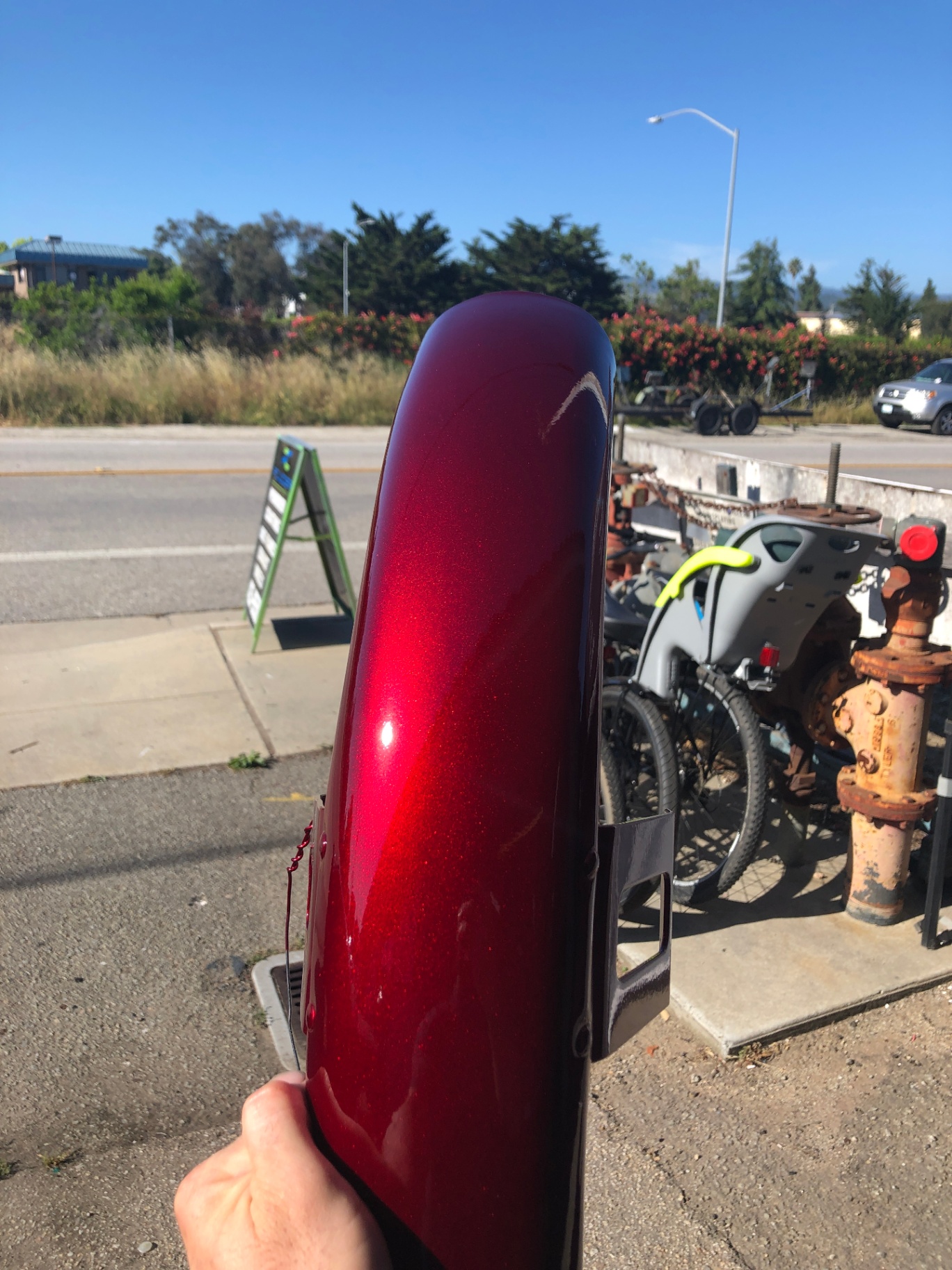 Candy red metallic motorcycle fender finished for high-visibility style while providing a durable protective layer against coastal salt and corrosion on sport bikes