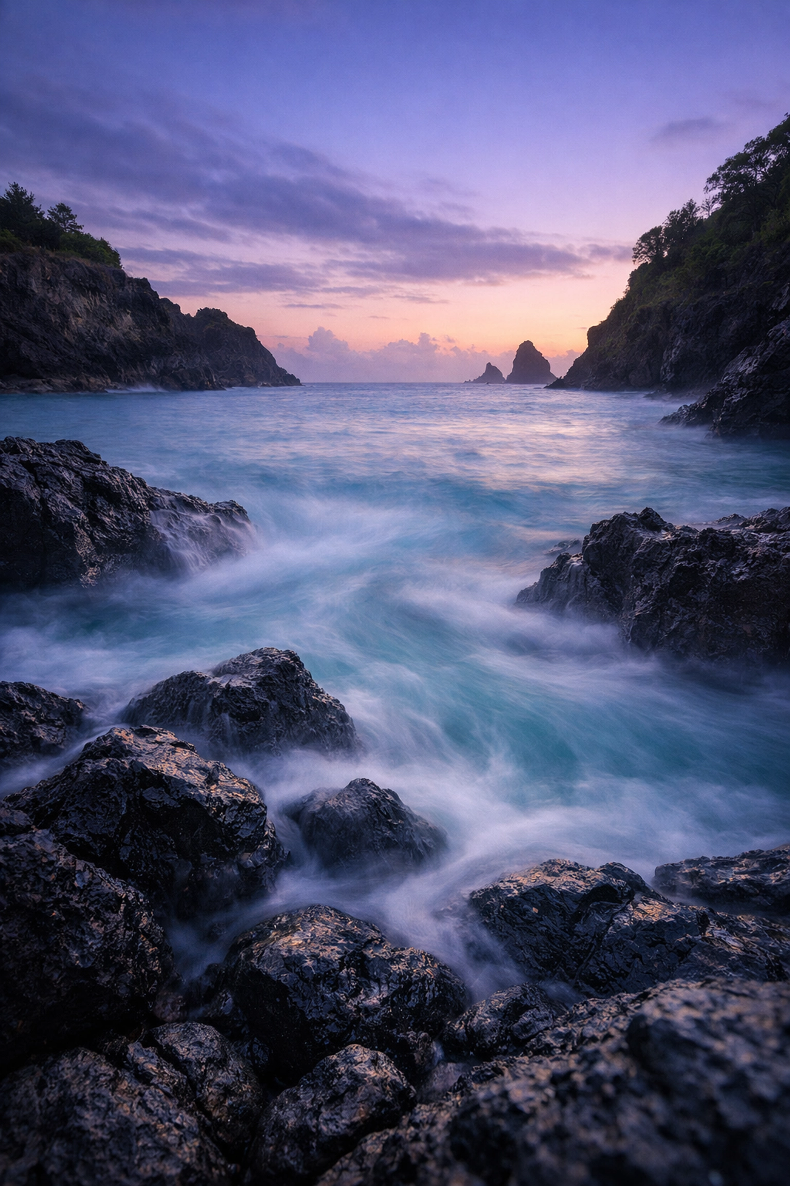 A long-exposure travel photography shot of a misty coastal cove, one of the best photography locations.