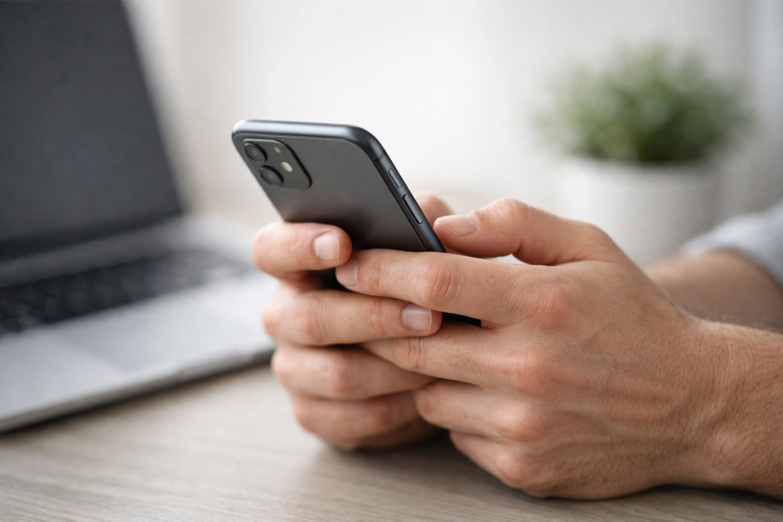 Person applying for a cash loan online in Canada using a smartphone in a modern home office.