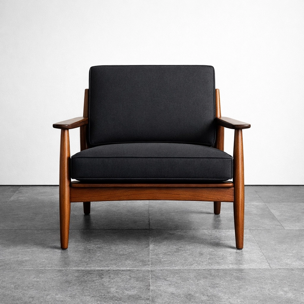 Restored mid-century modern armchair with custom charcoal cushions by Chattanooga upholstery experts.