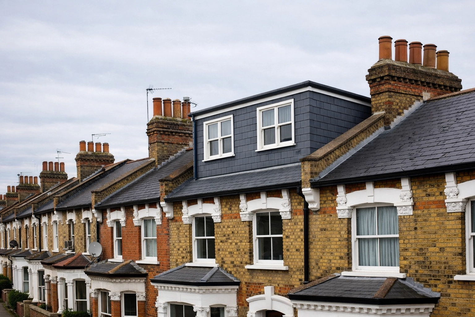 A dormer loft conversion on a traditional Victorian terrace house in East London, matching period architecture.