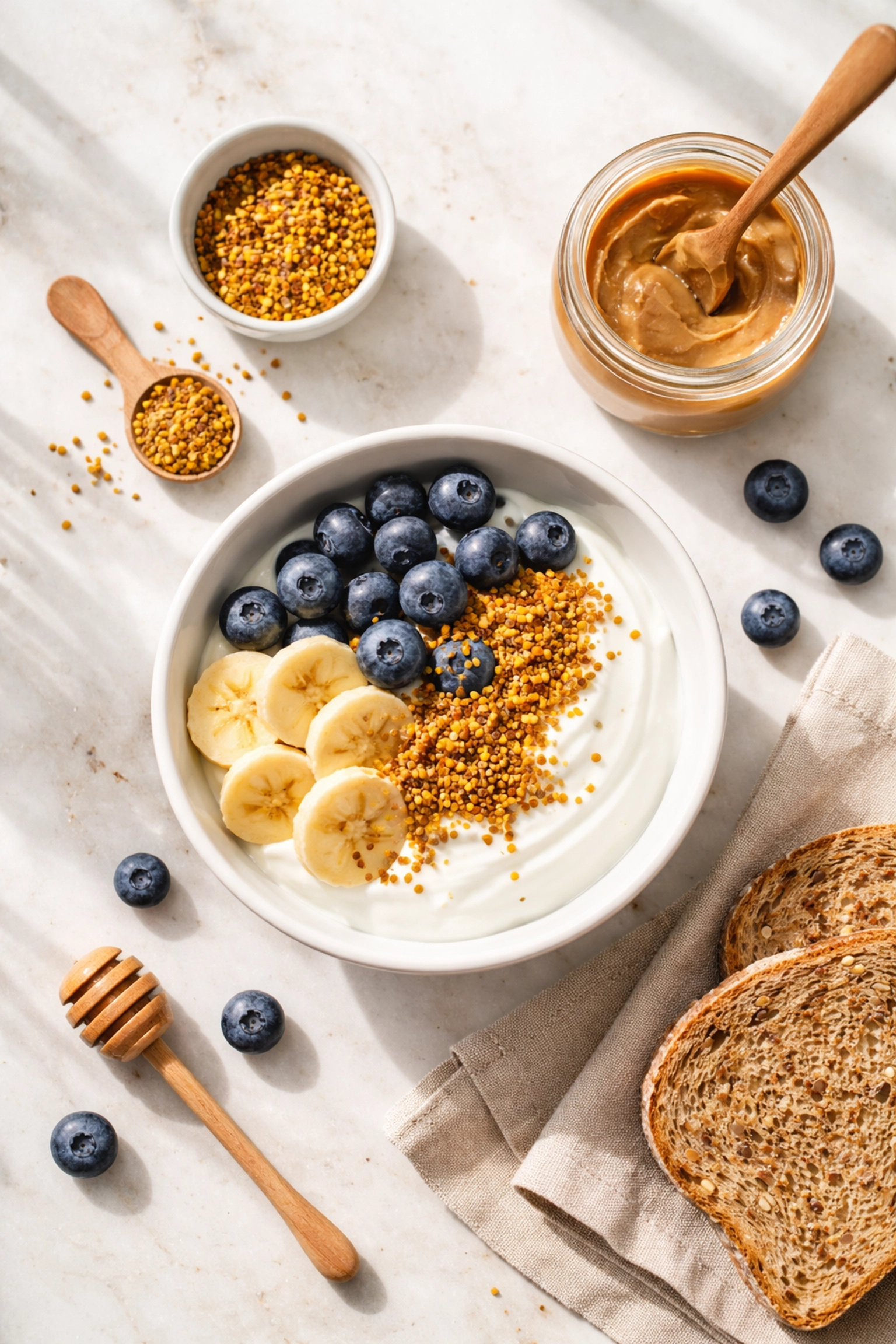 Healthy breakfast with yogurt, blueberries, banana, and bee pollen granules for a balanced daily routine