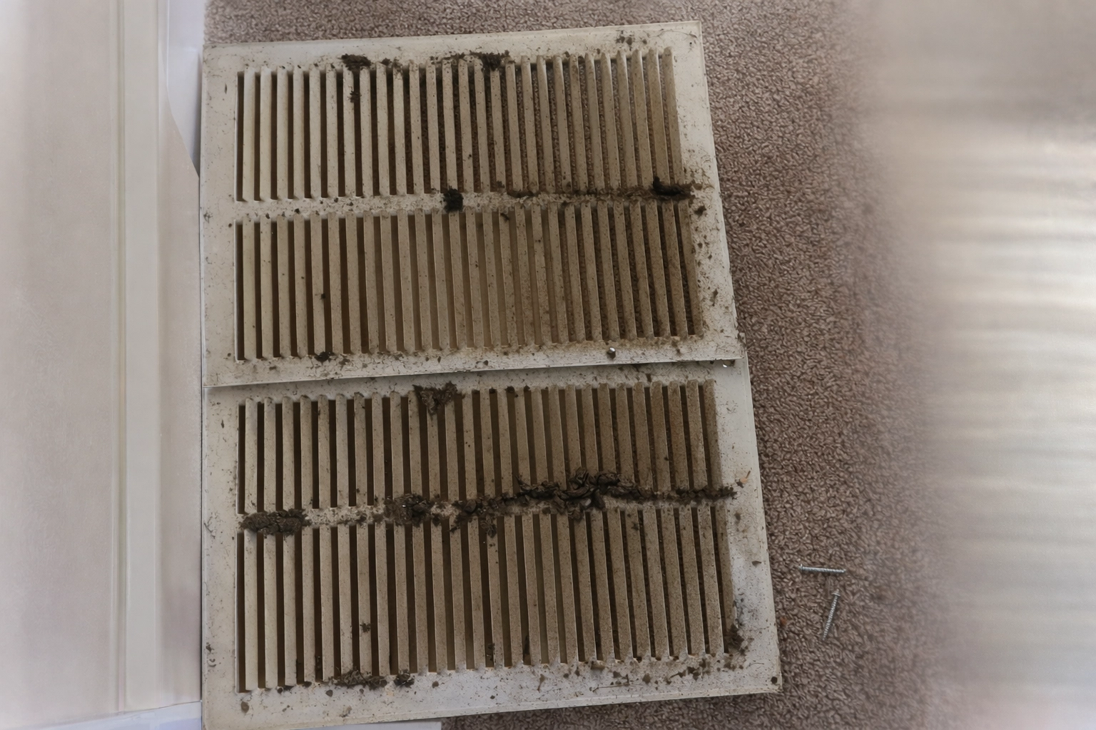 dusty-air-vent-covers-on-carpet.webp