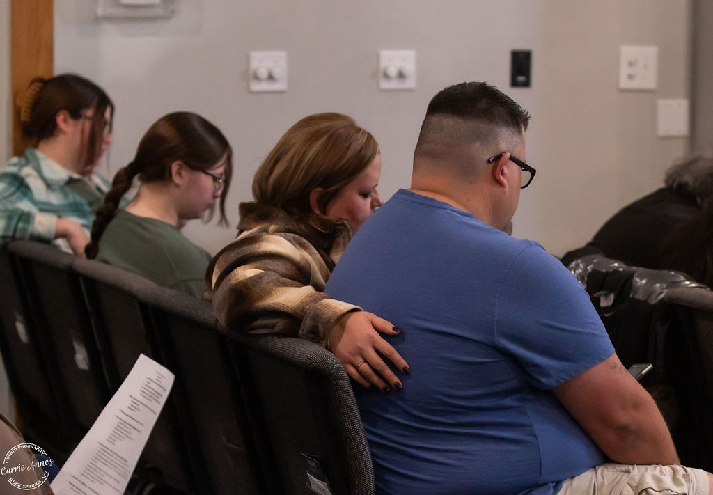 People praying and supporting one another in community