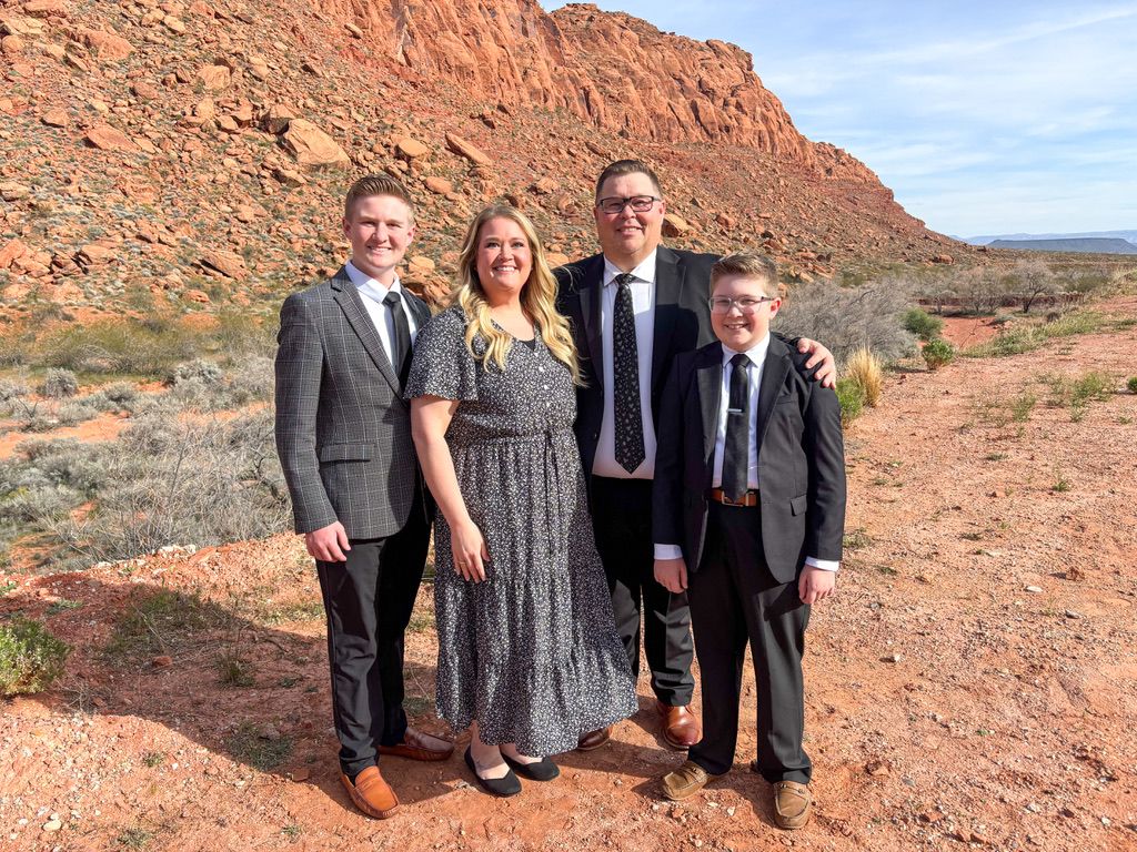 A family dressed in Sunday best against the scenic red rock landscape of Southern Utah