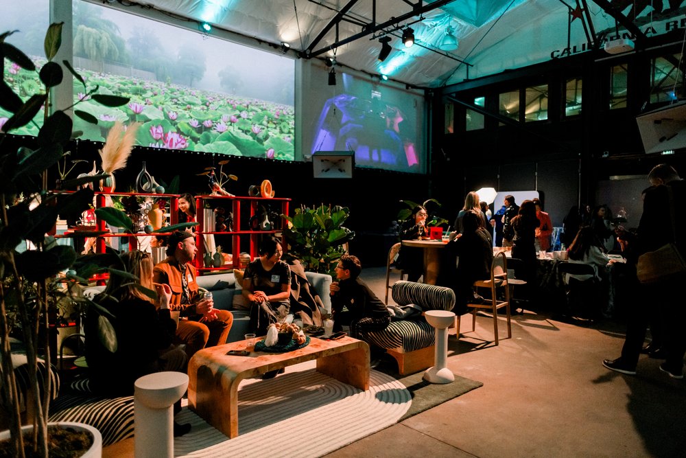 The Foundry SF Lounge seating with modern furniture and plants creates a relaxed networking area under high industrial ceilings
