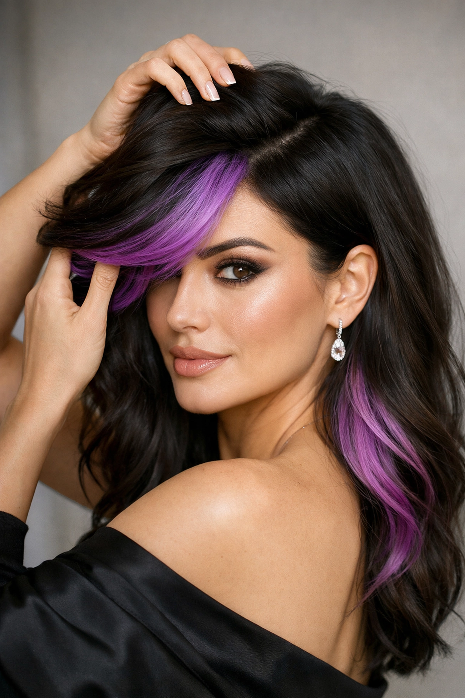 Hidden peak-a-boo orchid fashion color in dark hair at The Color Lounge Salon in Concord NH.