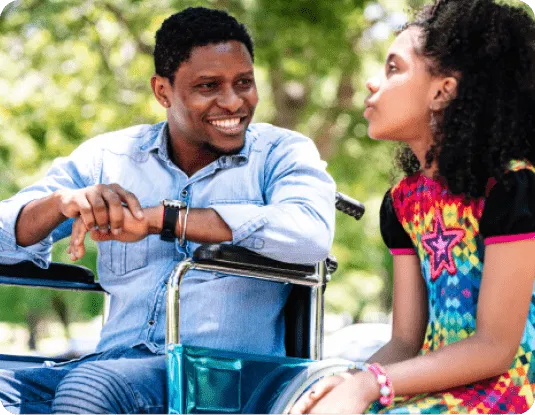 man-wheelchair-girl-intergenerational-companionship-outdoors.webp