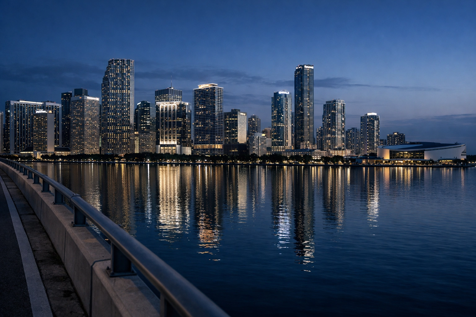 Night landscape of the Miami skyline and Brickell skyscrapers reflecting in Biscayne Bay.