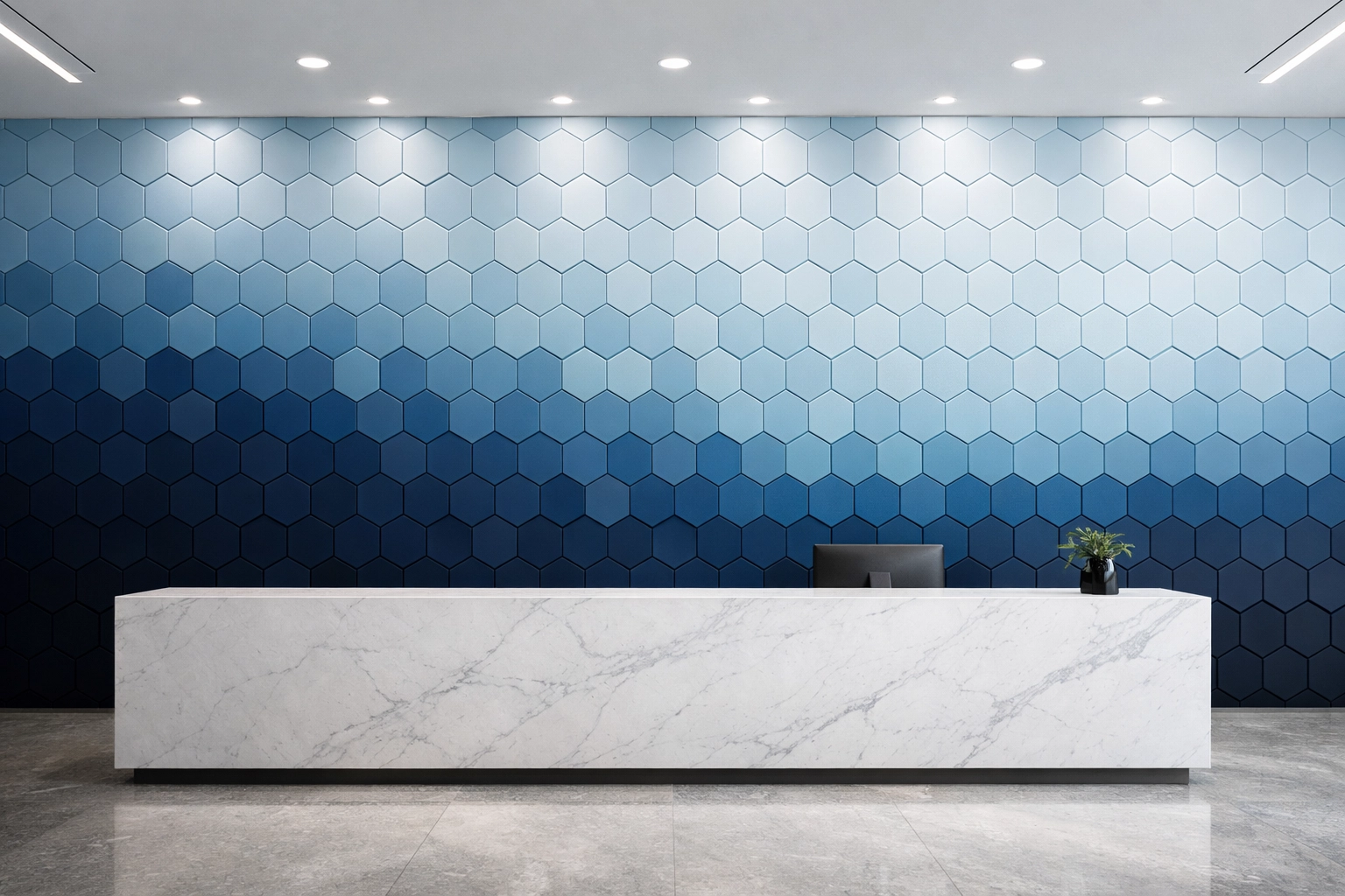 Hexagonal 3D acoustic panels with blue gradient in a modern office reception area.