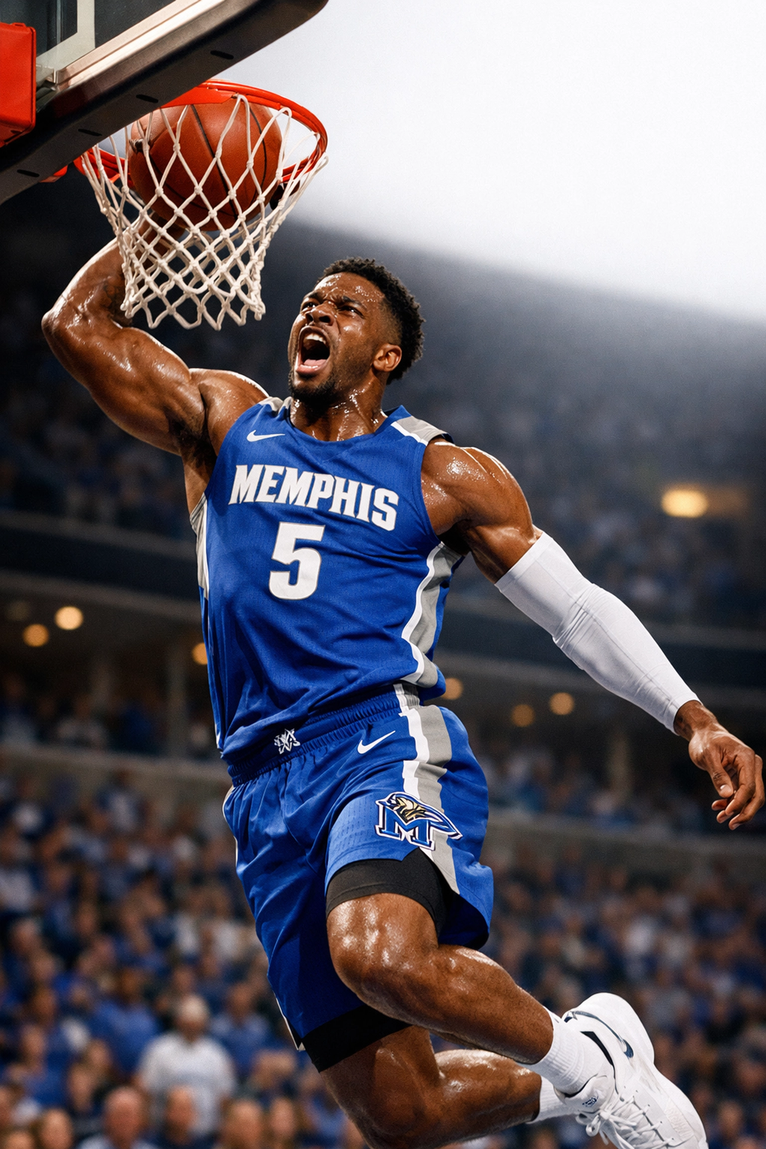Memphis Tigers basketball player performing a transition dunk during a 2026 game at FedExForum.