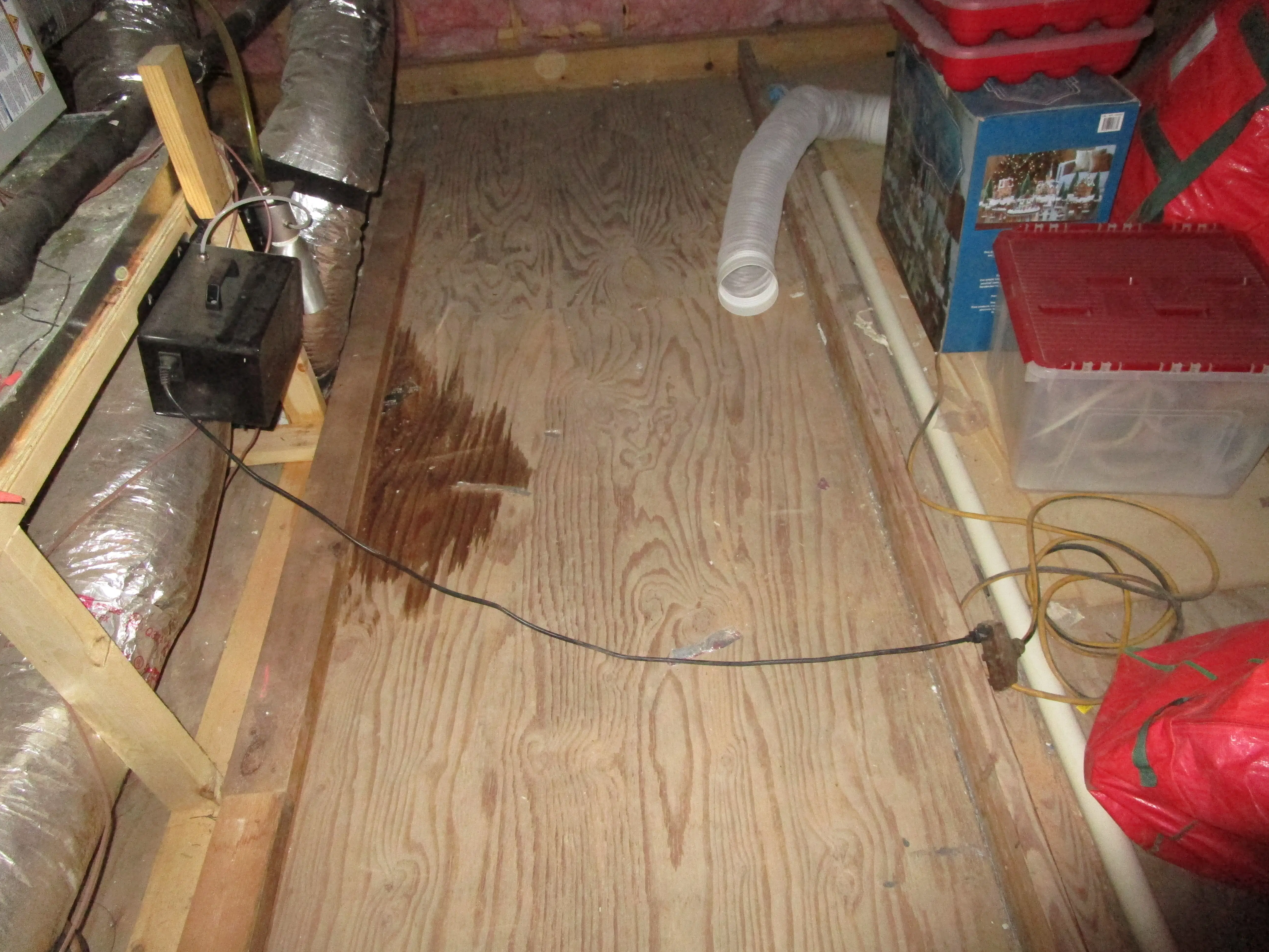 Attic mechanical area with signs of water staining near ductwork