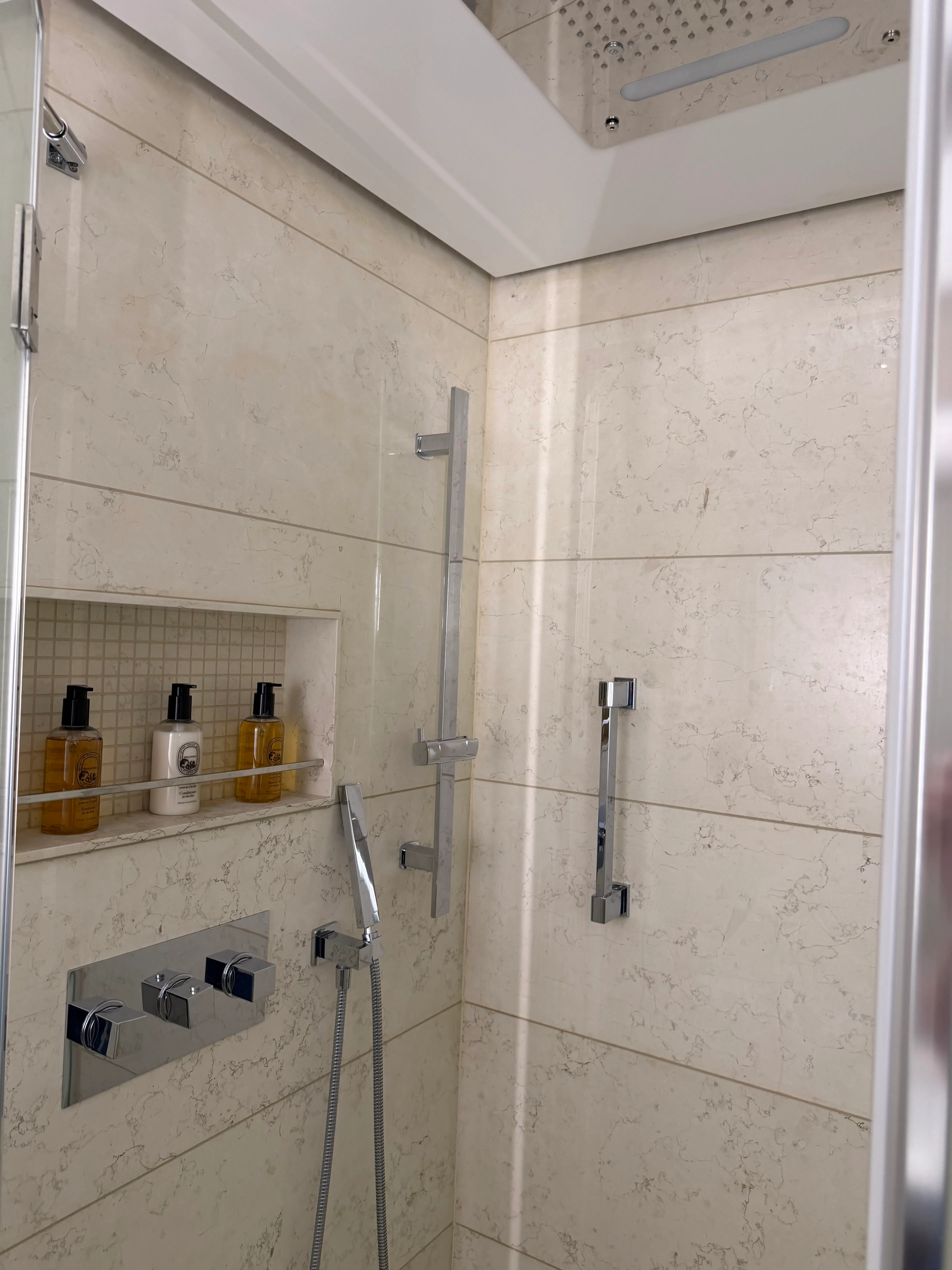 a shower with a shower head and shower head