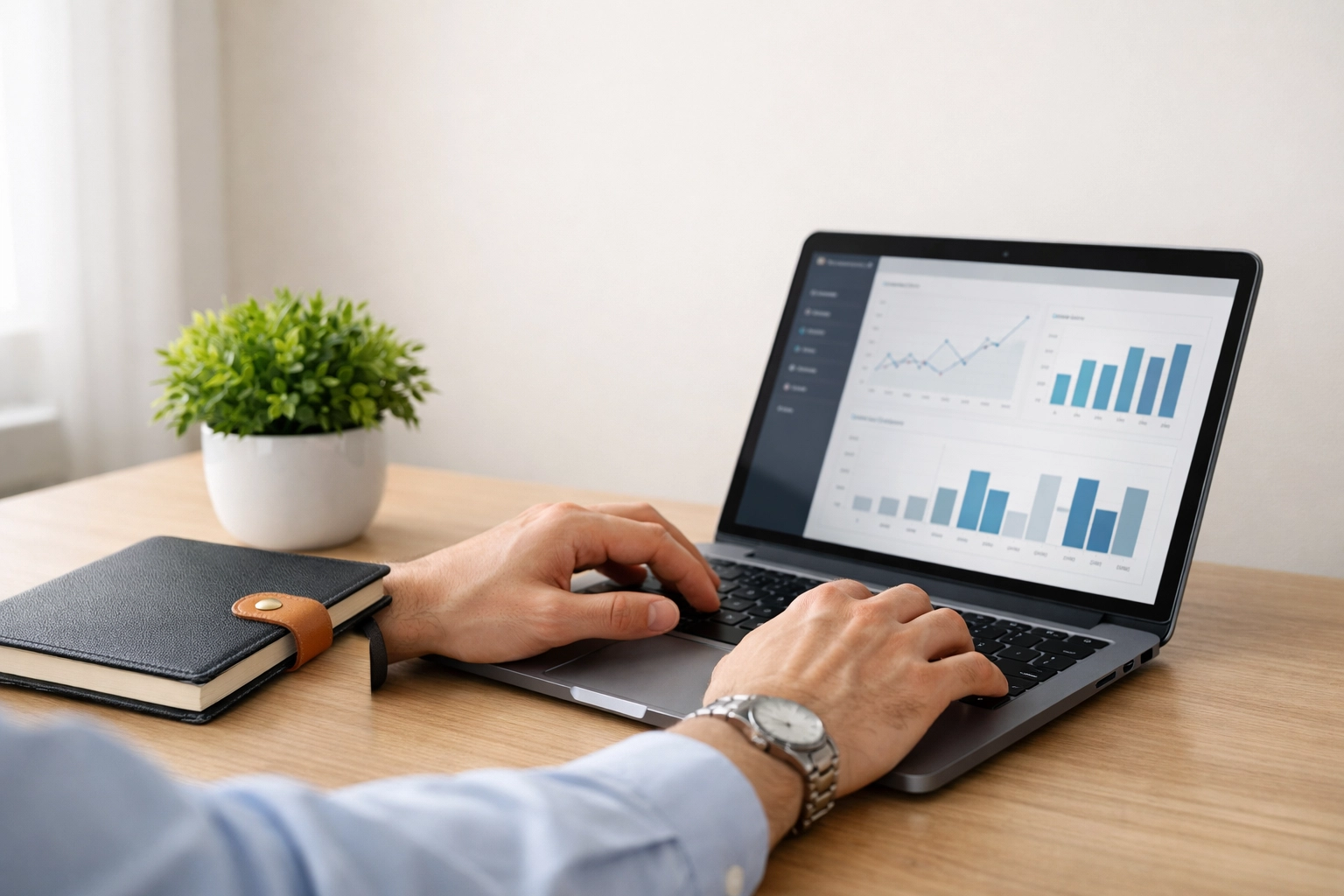 Hands using a laptop for secure, automated bookkeeping with clear audit trails.