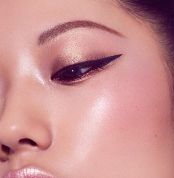 Close-up of model with defined brows and premium makeup
