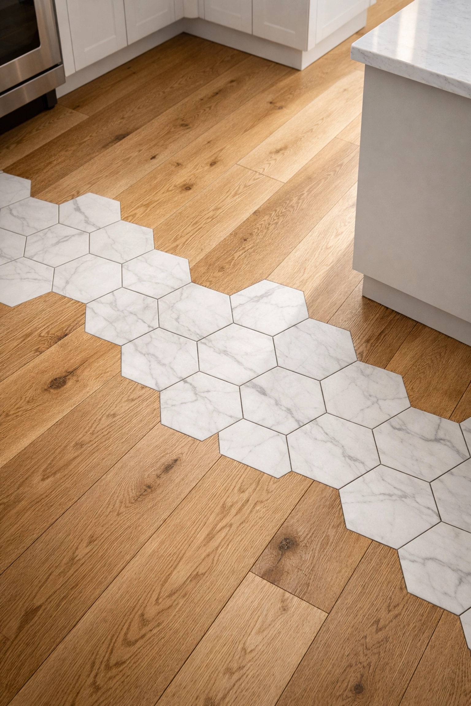 Seamless transition between white oak hardwood flooring and hexagonal marble tiles in a modern Chicago kitchen.