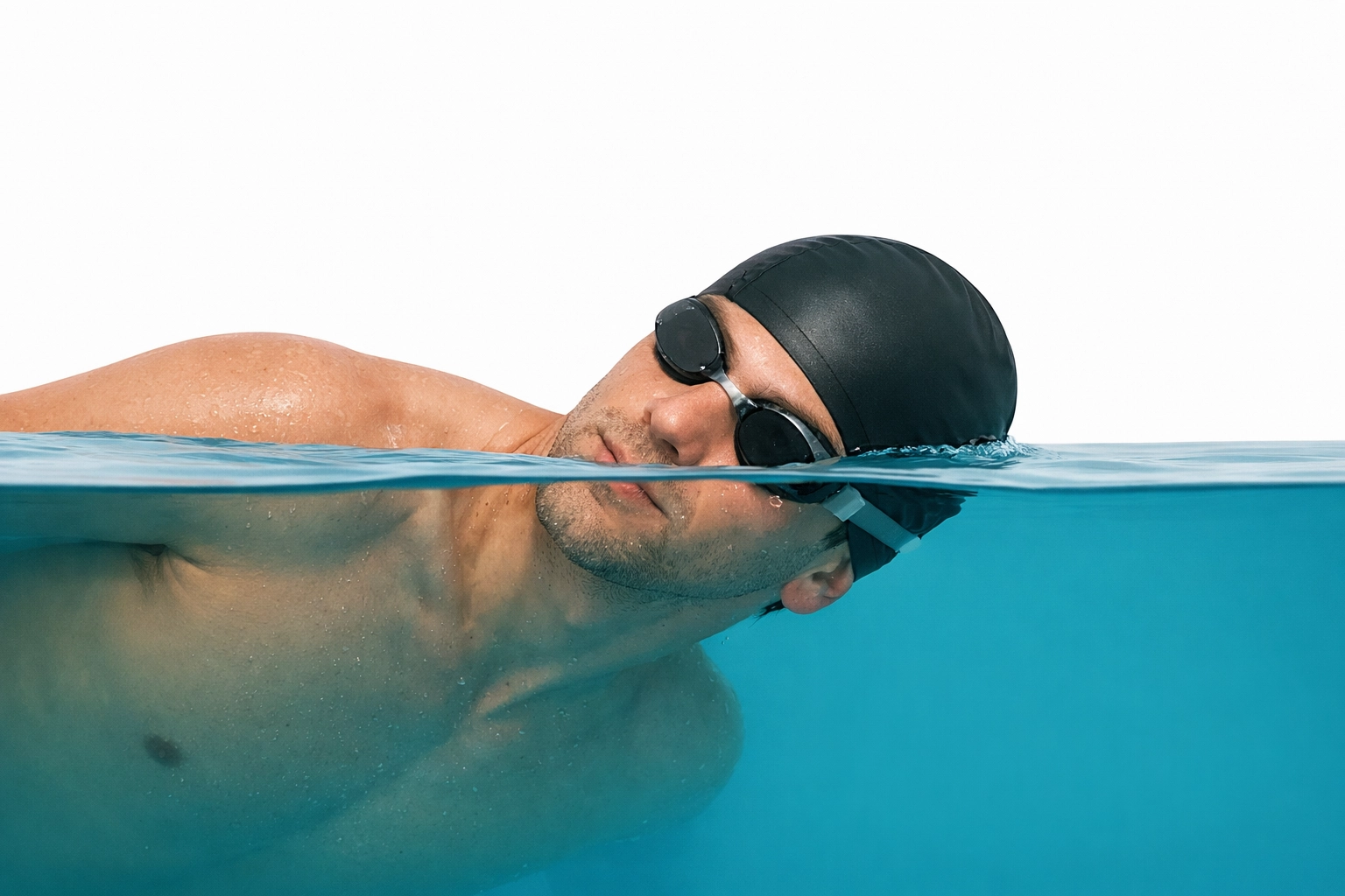 Swimmer rotating head with one goggle in the water for proper breathing technique.