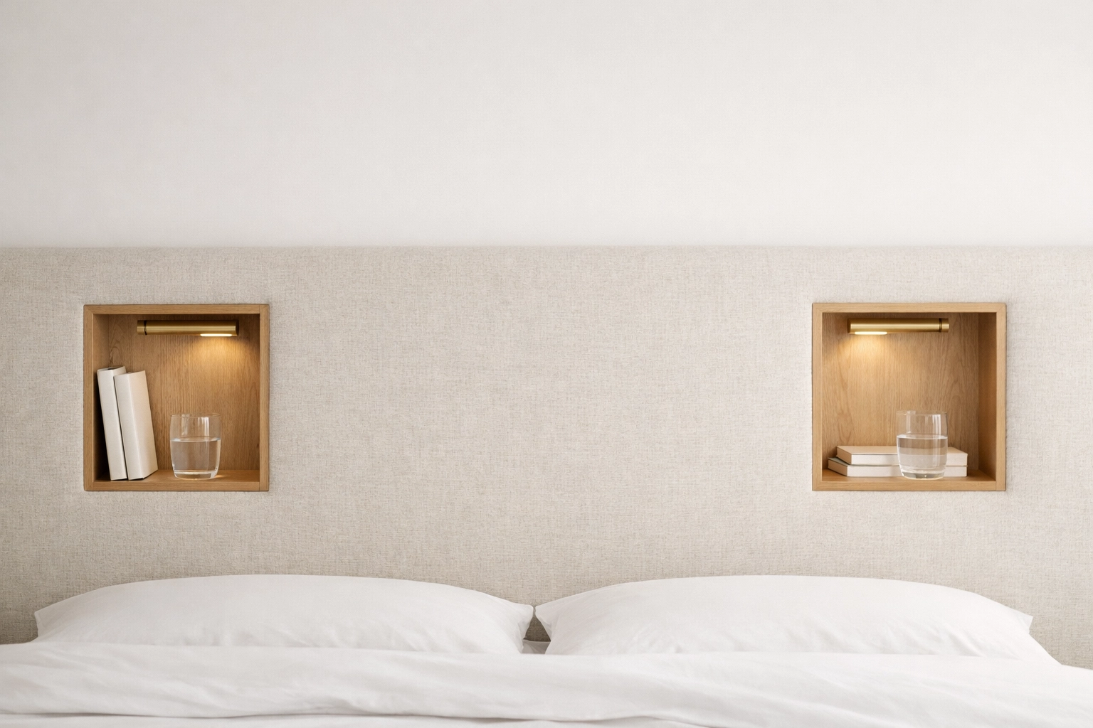 Bespoke upholstered headboard with integrated storage niches and reading light.