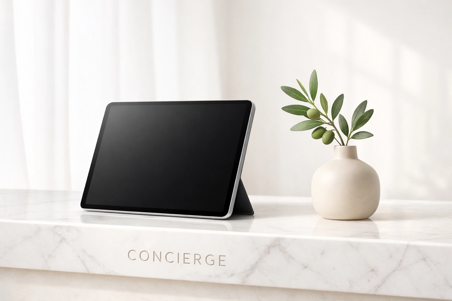 A sleek tablet on a minimalist marble desk symbolizing a modern, unified cloud-native hotel management platform.