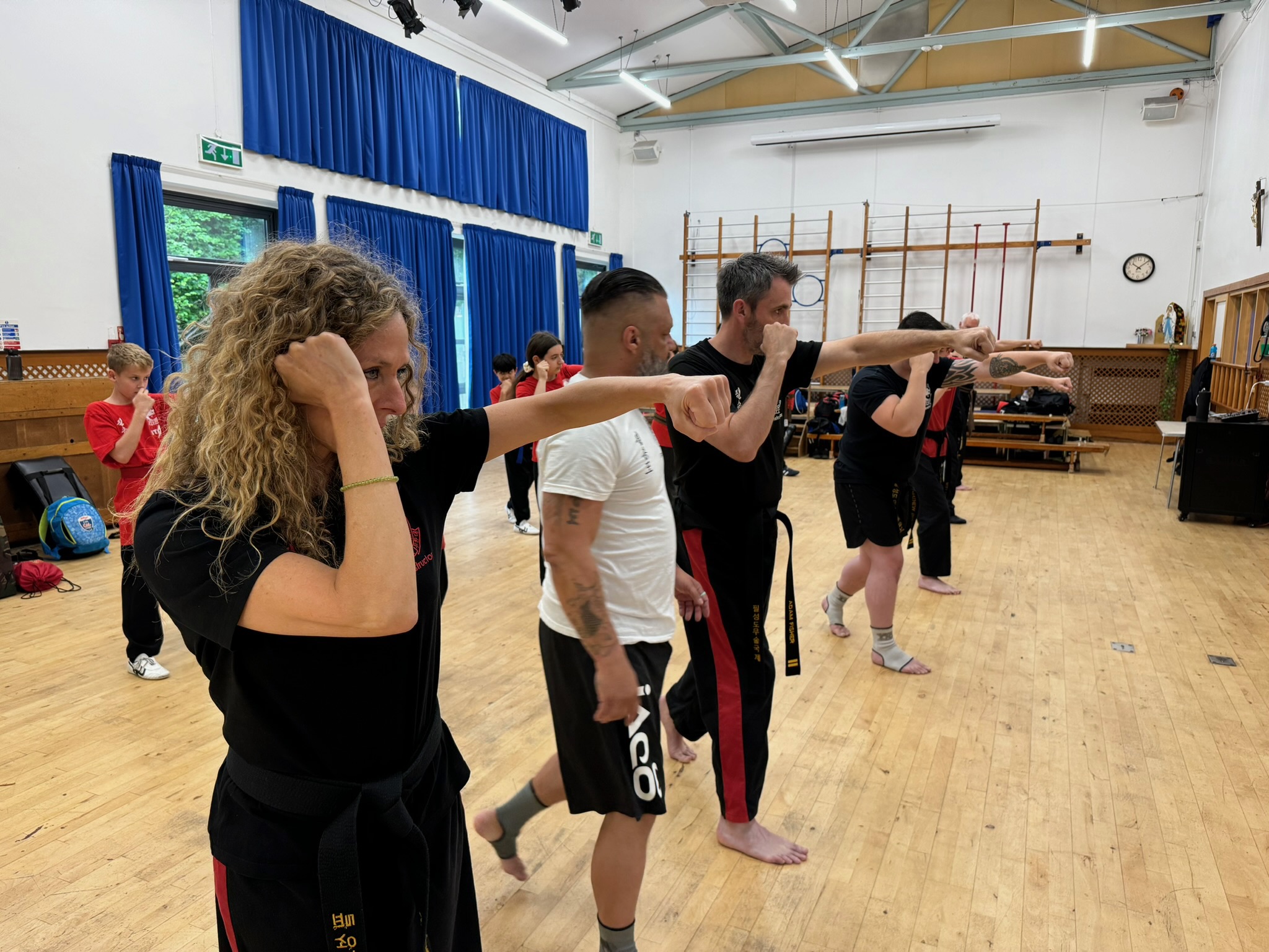 Adult martial arts class practicing techniques