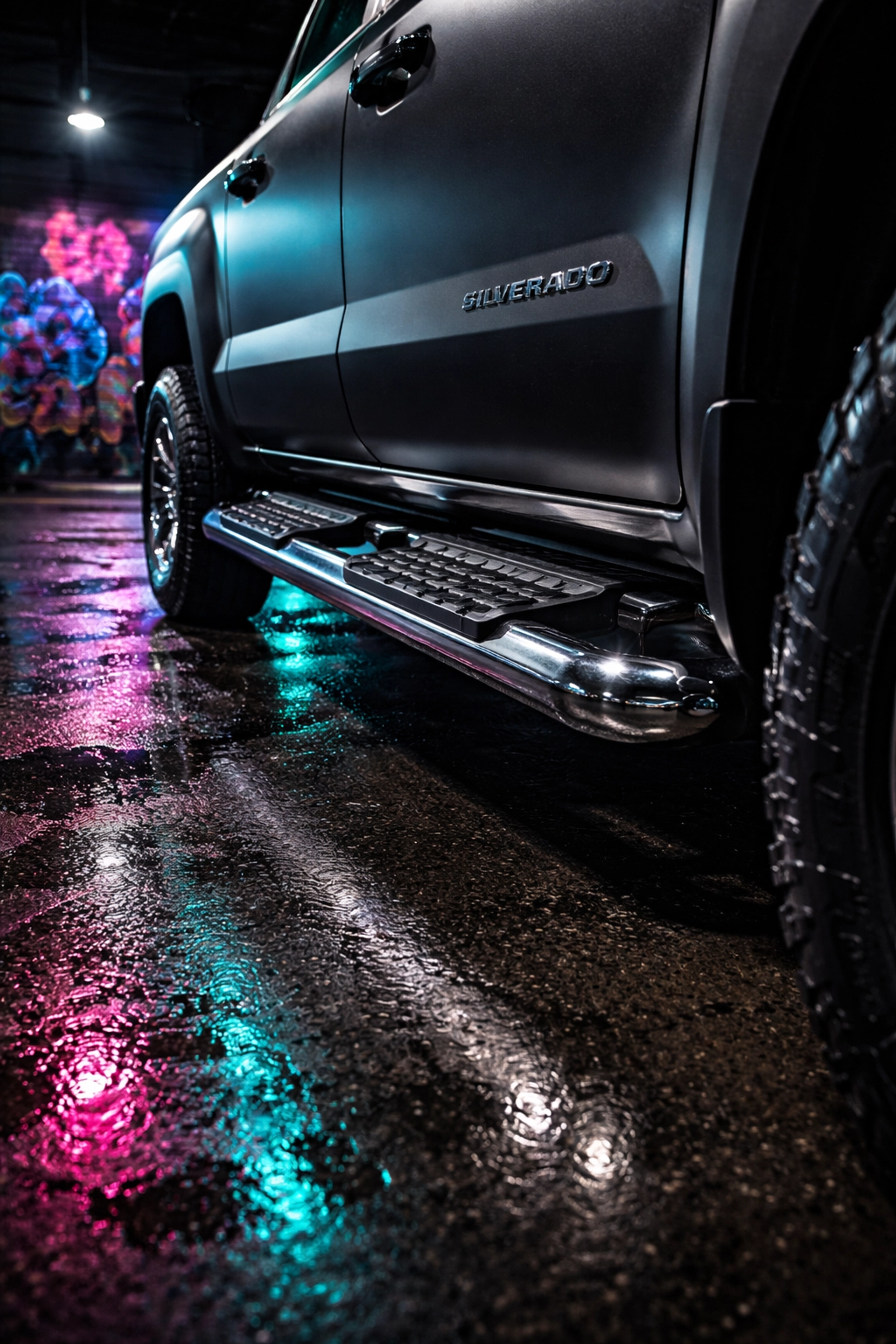 Chrome nerf bars and heavy-duty running boards on a matte black Chevy Silverado in an urban Pittsburgh setting